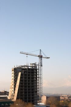Large crane build new house over blue sky