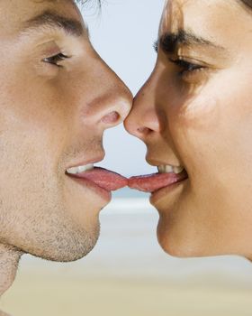 Portait of a young couple giving a tonge kiss