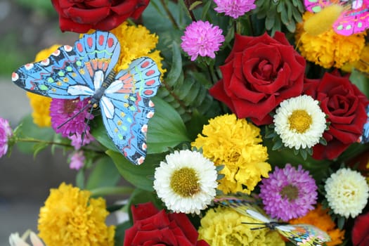 Flowers and artificial butterfly, flower background