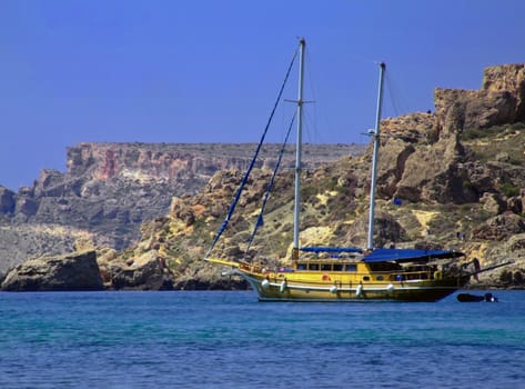 Yacht or sailing boat on calm ocean waters off the Mediterranean coast