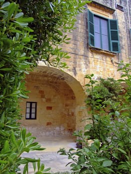 Medieval architecture within a palace courtyard in the Mediterranean island of Malta