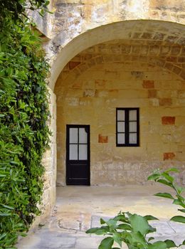 Medieval architecture within a palace courtyard in the Mediterranean island of Malta