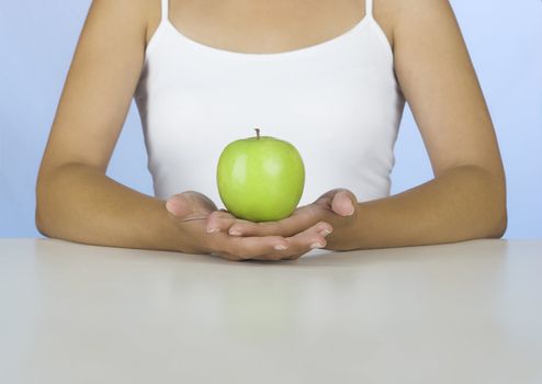 Picture of a Woman holding a green apple