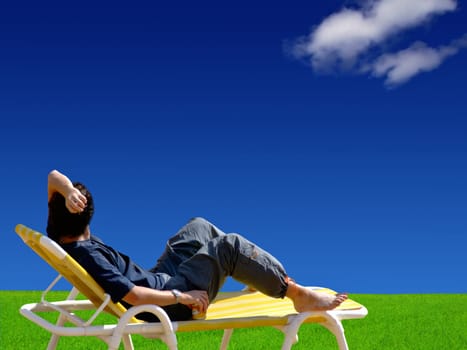 Conceptual image showing amazing blue skies over green meadows, with man relaxing on deckchair