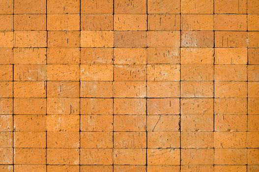 An abstract background created by closeup details blocks making up a yellowish brick wall.