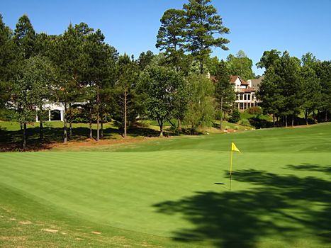 A photograph of a golf course in the afternoon.