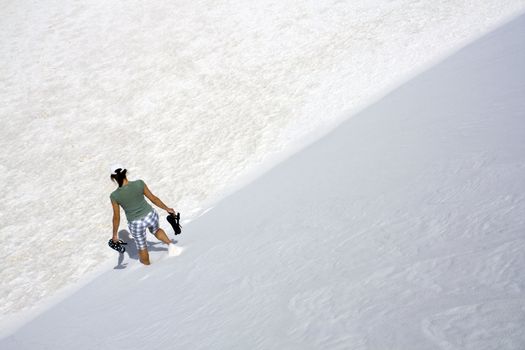Girl walking down the dune in White Sand Dunes National Park in New Mexico.