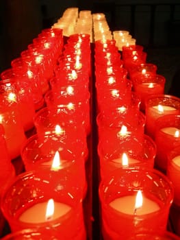 Red lit candles with a flickering flame