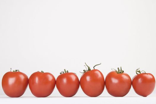 fresh red tomatoes ready for salad, arranged in line