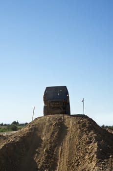 Jeep coming out of a muddy hole during a demonstration