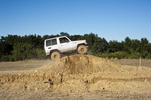 Jeep coming out of a muddy hole during a demonstration