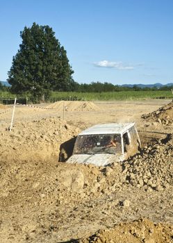 Jeep coming out of a muddy hole during a demonstration