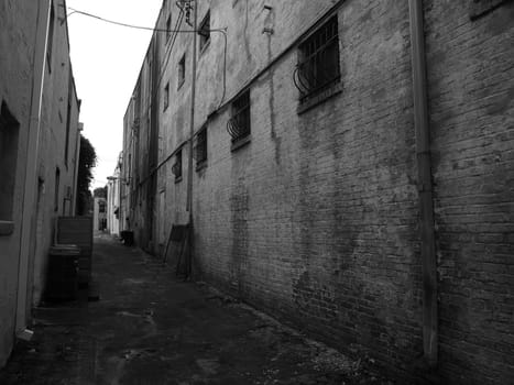 An alleyway in a southern city. Shown in black and white.