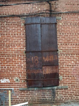 Old metal door on a brick building