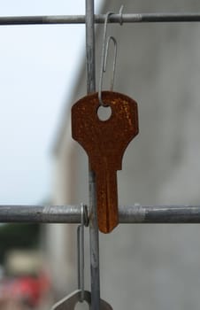 An old key hanging from a construction site in the city