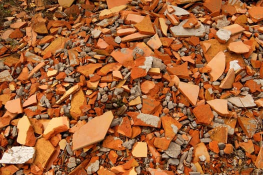 A pile of broken orange tiles and concrete pieces