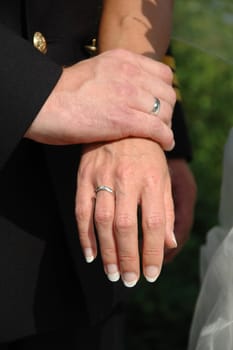 Wedding couple holding hands.