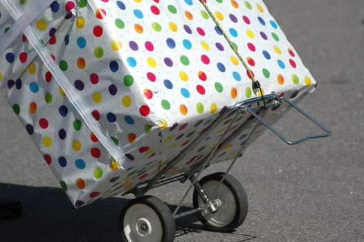 A very big present is transportated on a trolley.