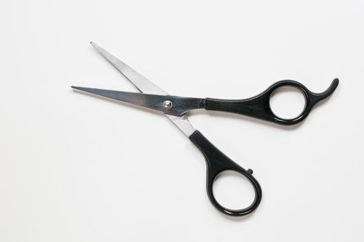 A pair of barber scissors with black handle