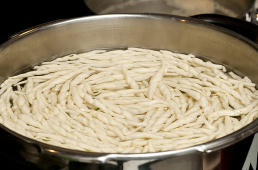 cooking traditional italian pasta in a large pot