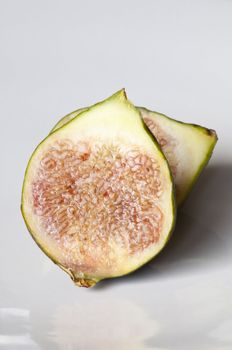Isolated fresh sliced figs in white background