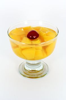 Peach compote with fresh sour cherry in glass isolated on white