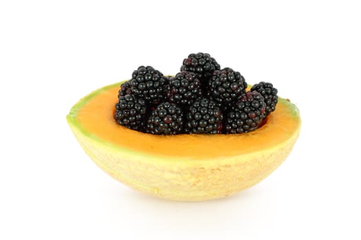 Ripe fresh blackberries in melon isolated on white