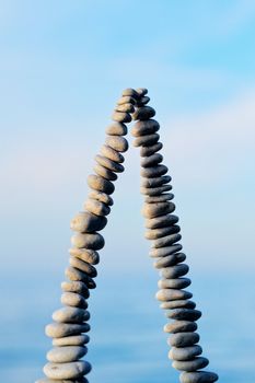 Pile of pebbles as pyramid against the background of sky