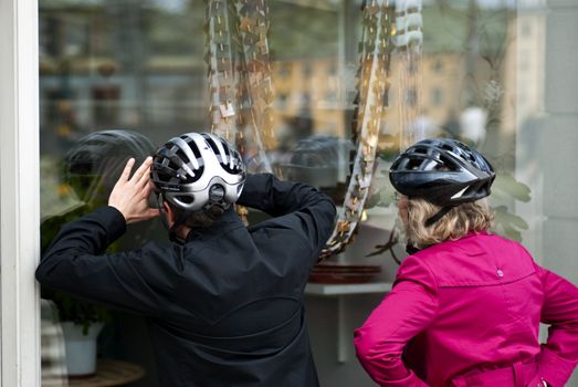 Two women wearing helmets windowshopping in Stockholm, Sweden. Picture taken May 16 2010