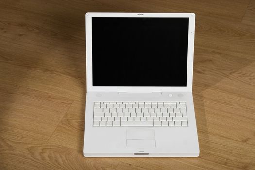 front view of white notebook on wooden background