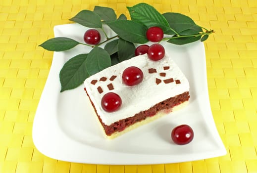 Sweet homemade cake with sour cherries on white plate