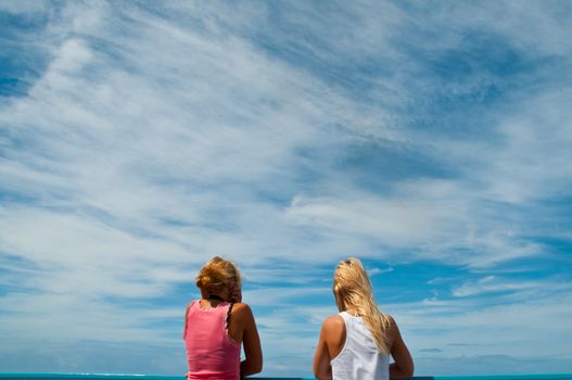 Two girls watching the ocean