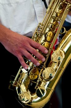 A man is playing on his sax.