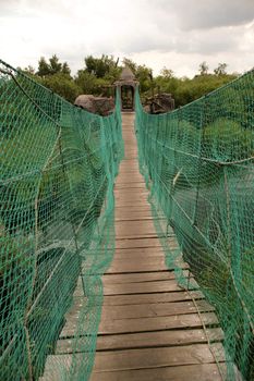 Suspension bridge over a river.