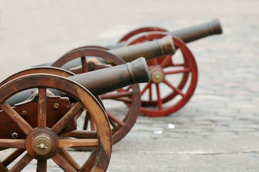 Three cannons are lined up for battle.