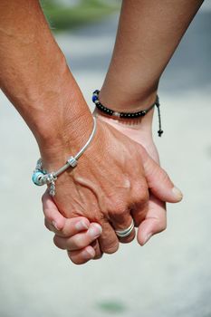 Mother and daughter holding hands.