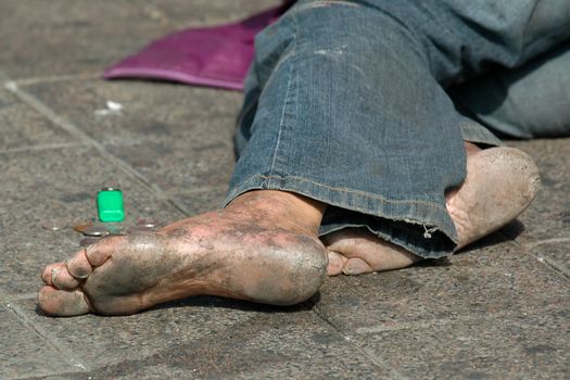 Homeless man with bare feet
