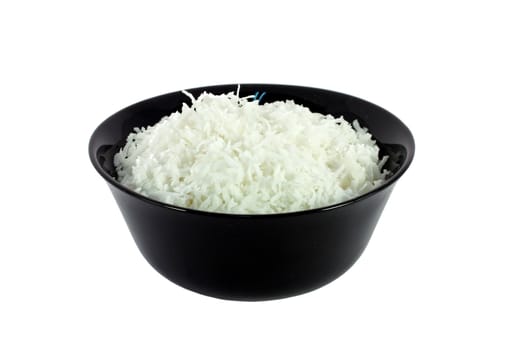 Black bowl full of coconut meal isolated on white