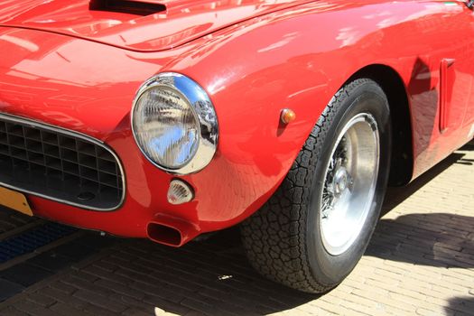 A red, vintage Italian sportcar in detail