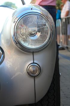 A shinny grey vintage sportscar in detail