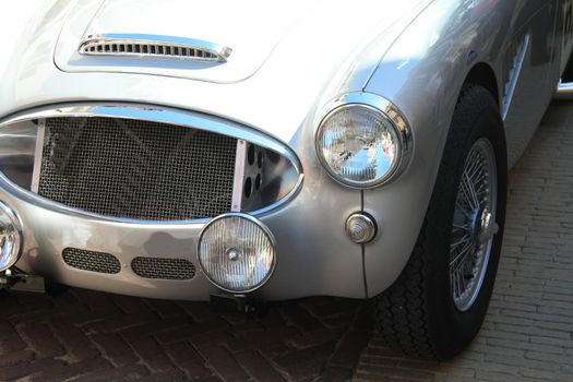 A shinny grey vintage sportscar in detail