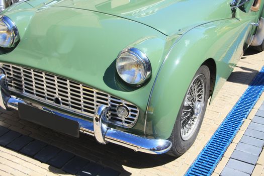 Detail of a classic green sportscar, made in England