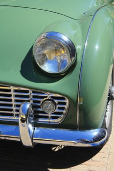 Detail of a classic green sportscar, made in England