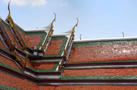 Beautiful traditional red and green Temple rooftop at the Grand Palace, Bangkok