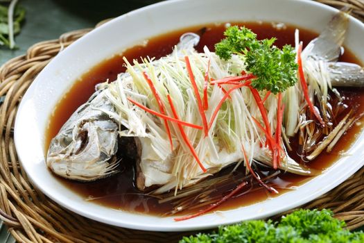 Chinese food, whole steamed fish in soy sauce on the dish