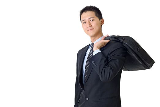 Successful young businessman with briefcase on shoulder with white copyspace.
