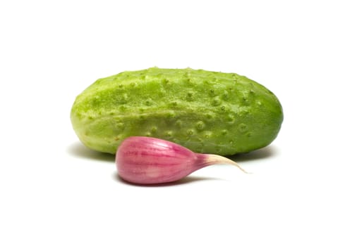 Cucumber and garlic clove on a white background.