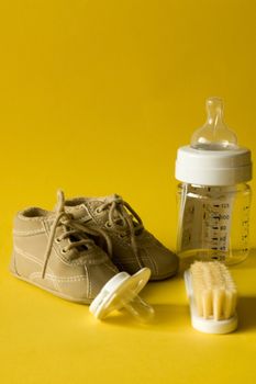 Essential children's accessories on yellow background , for each baby