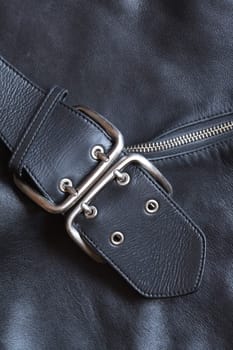 Closeup black leather background with belt and zipper