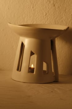 Ceramics lamp of perfume with burning candle